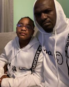 Tony James Nelson II with Daughter Savannah N. Taveras wearing new Roovet hoodies at home