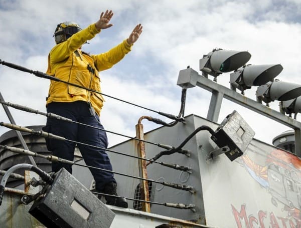 Boatswain’s Mate 3rd Class Nicole Zapata, from Tampa, Fla., receives an SA-330J Puma helicopter on the flight deck aboard the Arleigh Burke-class guided-missile destroyer USS John S. McCain (DDG 56) during a replenishment-at-sea with the dry cargo and ammunition ship USNS Alan Shepard (T-AKE 3). McCain is assigned to Destroyer Squadron Fifteen (DESRON 15), the Navy’s largest forward-deployed DESRON and the U.S. 7th Fleet’s principal surface force. (U.S. Navy photo by Mass Communication Specialist 2nd Class Markus Castaneda)