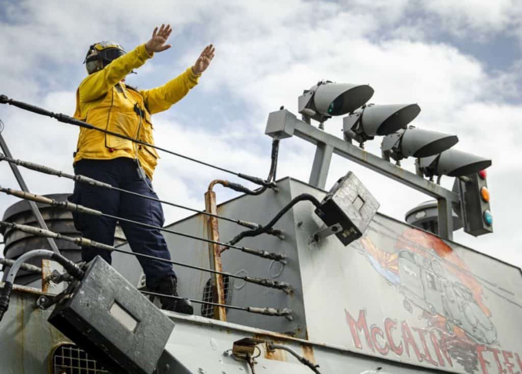 Boatswain’s Mate 3rd Class Nicole Zapata, from Tampa, Fla., receives an SA-330J Puma helicopter on the flight deck aboard the Arleigh Burke-class guided-missile destroyer USS John S. McCain (DDG 56) during a replenishment-at-sea with the dry cargo and ammunition ship USNS Alan Shepard (T-AKE 3). McCain is assigned to Destroyer Squadron Fifteen (DESRON 15), the Navy’s largest forward-deployed DESRON and the U.S. 7th Fleet’s principal surface force. (U.S. Navy photo by Mass Communication Specialist 2nd Class Markus Castaneda)                                                                                                         