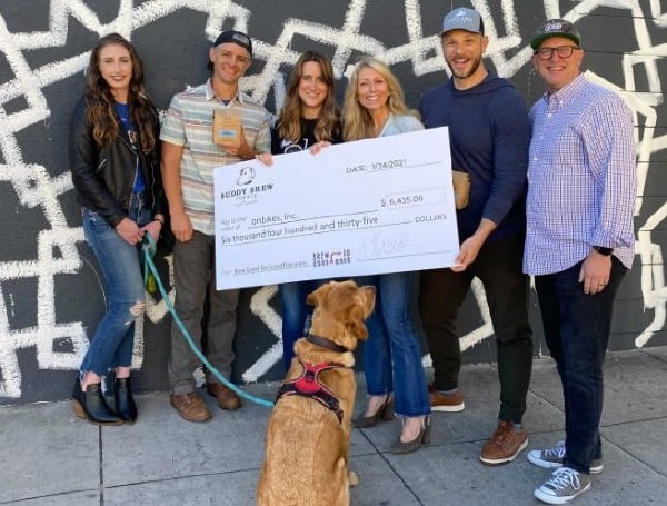 Pictured (L-R): Breann Stampiglia (Buddy Brew wholesale customer service manager); Phil Holstein (Buddy Brew director of coffee); Sarah Breseman (executive director, onbikes); Susan Ward (Co-founder, Buddy Brew); (Julius Tobin, co-founder, onbikes); Dave Ward (co-founder Buddy Brew Coffee) and Buddy the Dog. (Photo courtesy of Buddy Brew Coffee)