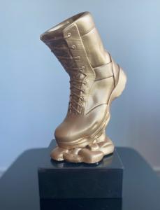 Image of a bronze soldiers' boot on a black marble stand