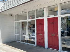 Image shows front of the new gallery at 2323 Central Avenue with red front door and glass front.