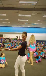 Dr. Simone in front of group of kids at Camp Katina