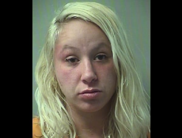 A Florida woman at a Destin restaurant was arrested Monday afternoon after she passed out on the deck while a one-year-old child was in her care.