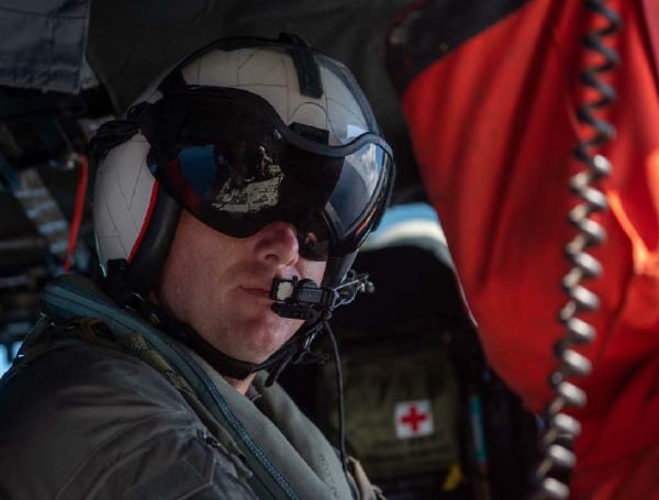 Christopher Fred, from Sarasota, Fla., assigned to the “Wildcards” of Helicopter Sea Combat 23 (HSC 23) transits the South China Sea in an MH-60S Seahawk helicopter