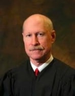 ECIMOS v Carrier Global portrait of a robed Judge Jon P McCalla