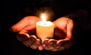 5611325 hands with candle 300x183 1