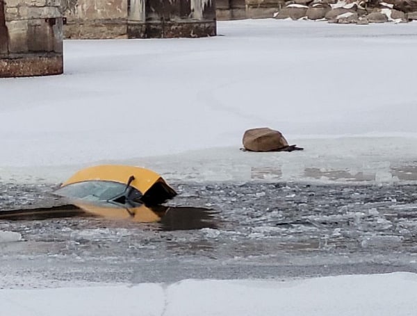 Local residents used a kayak to rescue a woman whose car fell into icy water after she attempted to drive over a frozen river, police said in a statement.