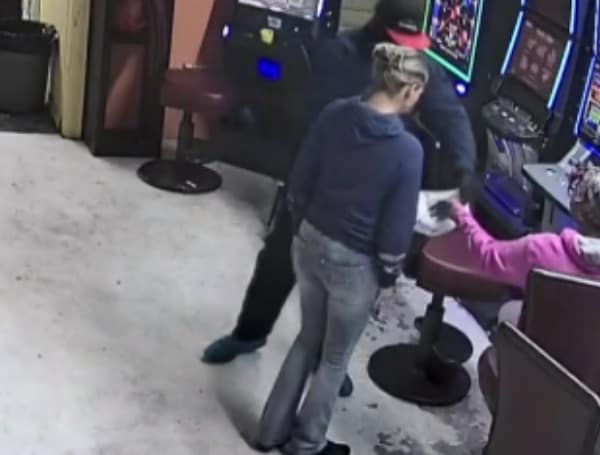 A Georgia woman was arrested last week for theft after taking lottery tickets from an office where a store clerk was lying dead following an armed robbery in Houston County, Georgia, 13 WMAZ reported.