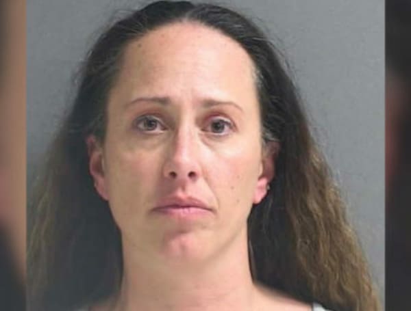 Kristen Williams, 41, an office assistant who works with 6th graders at Heritage Middle, was charged with child abuse without great harm and contributing to the delinquency of a minor.
