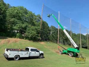 Netting Contractor installing the extension of the netting panels at The First Tee of Atlanta.