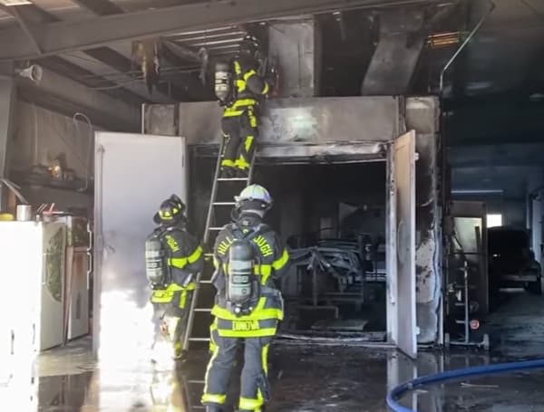 Hillsborough County Fire Rescue was dispatched to a commercial fire at Maaco Bodyshop located at 9801 Palm River Road. The first unit arrived on scene at 4:48 pm to find smoke and flames showing from the roof. The crew pulled a handline and made an interior attack, quickly knocking down the fire. The fire was isolated to the area directly adjacent to the paint room's ventilation system. Crews are currently working on the roof and cutting through the interior ventilation chimney, looking for additional fire or smoldering. No injuries were reported from civilians or firefighters, and an HCFR Fire Investigator is on scene. Video available on Facebook.