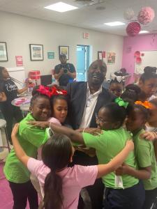 Microsoft executive Bruce Jackson and the Embrace Girls enjoy one of the group's signature Tea Parties