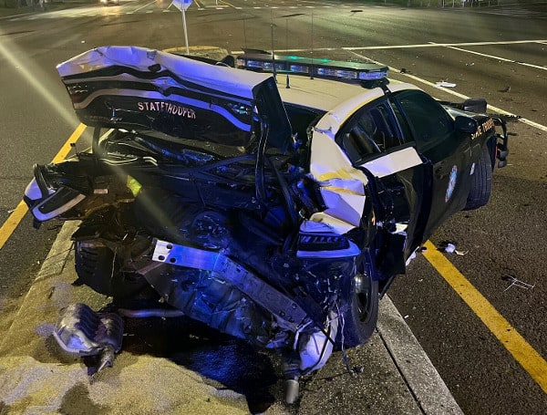 A 47-year-old Tarpon Springs man was arrested after crashing into a Florida Highway Patrol Car that was investigating a crash Saturday.