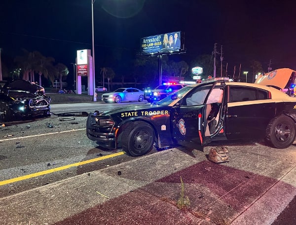 A 47-year-old Tarpon Springs man was arrested after crashing into a Florida Highway Patrol Car that was investigating a crash Saturday.