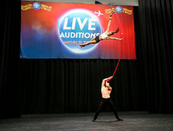 Husband and wife duo, Denis and Jillian Bazhenov of Ukraine, keep casting on the edge of their seat during an aerial strap performance at the Ringling Live Auditions World Tour in Las Veg as