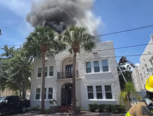 Fire officials say that Engine 15 arrived first to the Kansas Ave. Apartments with smoke showing from the roof. The fire seems to have originated on the roof, according to officials.