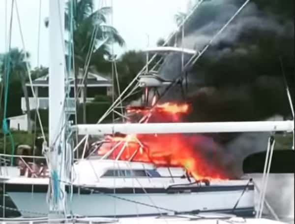 Deputies come to the rescue of a man after a boat explodes at a marina in Florida on Sunday.