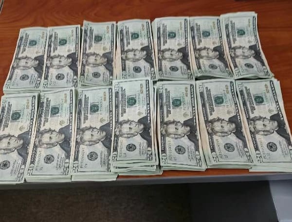 Two people have been arrested after one of them tried to spend counterfeit cash at a Dollar General store.