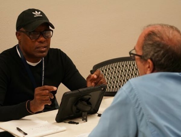 FEMA Personnel Speaks with Survivor About Recovery Assistance (Photo by FEMA Photographer)