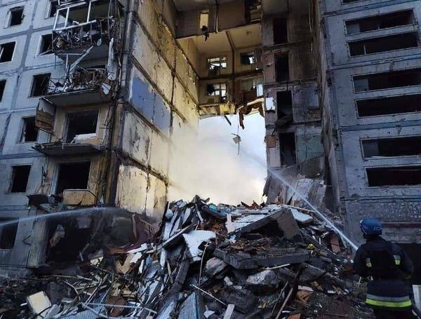 Russian forces pounded apartment buildings and other targets in the Ukrainian city of Zaporizhzhia, killing at least 17 people and wounding dozens, officials said Sunday.