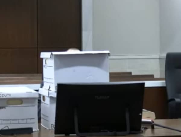 The alleged Waukesha, Wisconsin, Christmas parade killer piled boxes obscuring himself from camera view Monday after the judge once again sent him to another room for hindering proceedings.