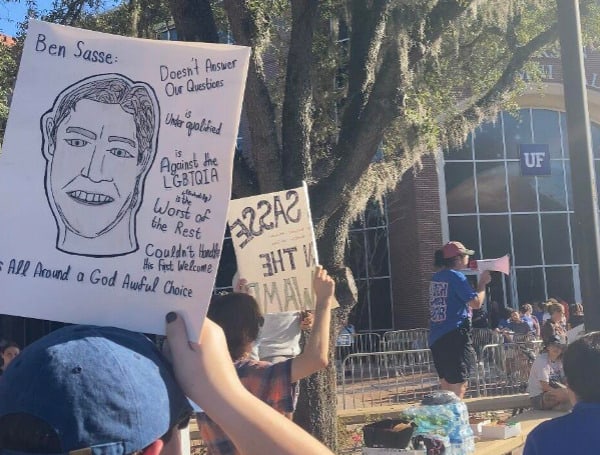 Students protest as University of Florida leaders unanimously approve U.S. Sen. Ben Sasse, R-Neb., as the school's next president. The state university system's Board of Governors will have the final say in Sasse's selection. (Mike Exline/The News Service of Florida)