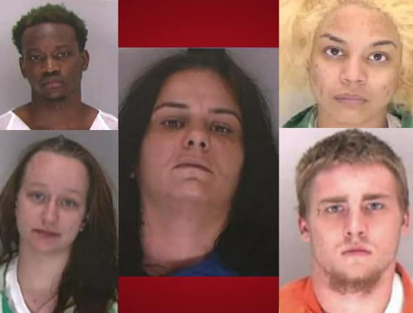 Five people have been arrested after a woman was found naked in a trailer, being held in dog cage as a sex slave, according to authorities. 