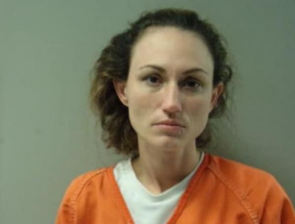 A Florida woman with outstanding warrants in two counties slammed a door on deputies Saturday morning when they went to serve those warrants at a home on Sugartown Road in Okaloosa County,
