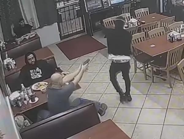 Security footage captured the moment when a customer fatally shot an armed robber who pointed a gun at multiple customers inside a restaurant in southwest Houston, Texas, on Thursday night.