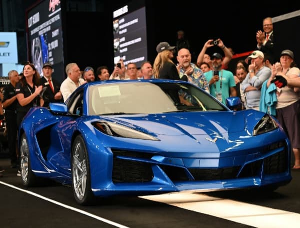 Front 3/4 view of 2024 Chevrolet Corvette E-Ray in Riptide Blue crossing the auction block at the 2023 Barrett-Jackson Palm Beach auction.