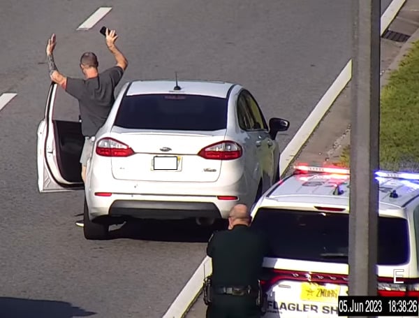 A 50-year-old Florida man was arrested after pointing a gun at another driver on SR-100 on Monday, according to deputies in Flagler County.