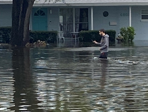 St. Petersburg Shore Acres Resident Standing In Flooded Street Following Hurricane Idalia Impact (Photo By Cliff Gephart)