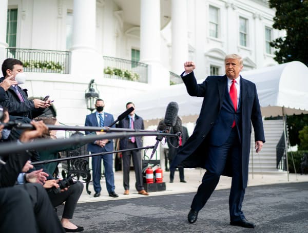 President Donald J. Trump gives a fist bump to the press Friday, Oct. 30, 2020, prior to boarding Marine One en route to Joint Base Andrews, Md. to begin his trip to Michigan, Wisconsin and Minnesota. (Official White House Photo by Tia Dufour)