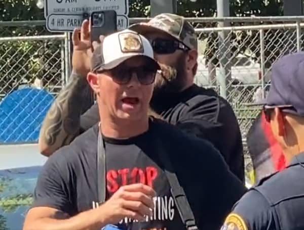 A Navy seal is under investigation for suspected association with unspecified extremist organizations after photos and videos surfaced of him speaking with members of the Proud Boys at parental rights protests, according to media reports and the visual documentation.