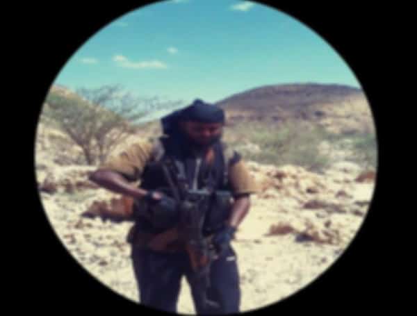 Abdi also sent a photograph of himself carrying an AK-47 assault rifle (DOJ)