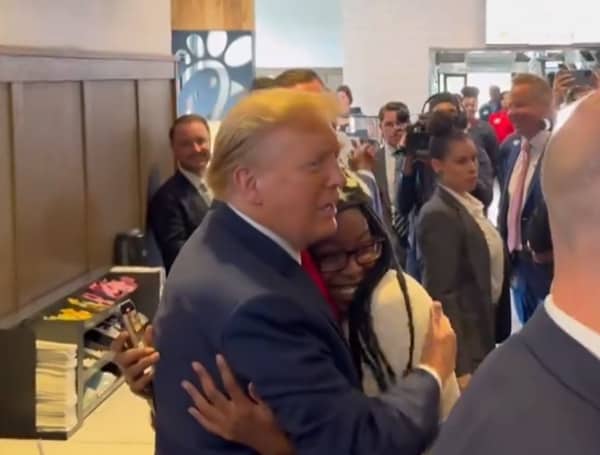After hugging former President Donald, the woman who went viral fires back at critics.