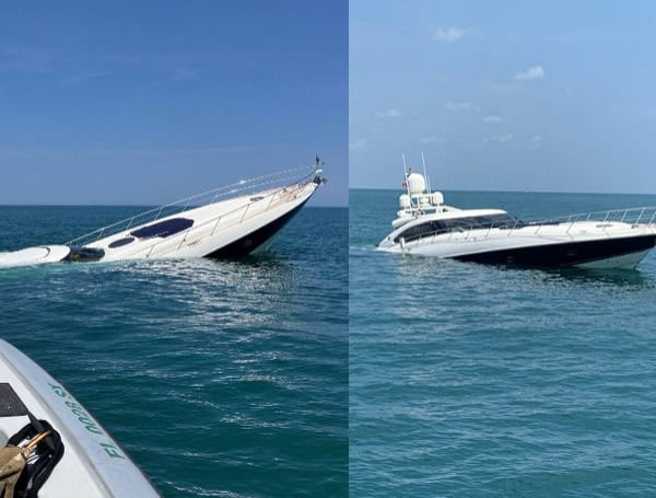 The Atlantis, an 80-foot motor yacht, takes on water after reportedly striking an object (U.S. Coast Guard courtesy photo)